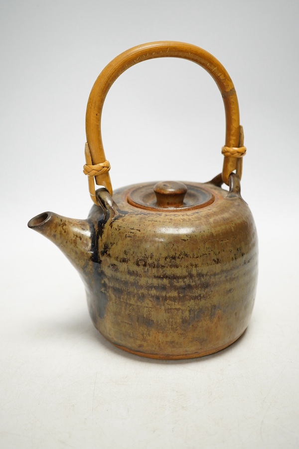 Pierre Culot (Belgian, 1938-2011), a studio pottery teapot with bamboo handle, stamped to the foot rim, 23cm high. Condition - fair to good, minor chipping